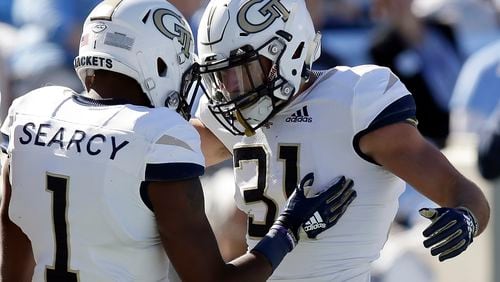 Georgia Tech's Qua Searcy (1) congratulates Nathan Cottrell (31) following Cottrell's touchdown against North Carolina during the first half of an NCAA college football game in Chapel Hill, N.C., Saturday, Nov. 3, 2018. (AP Photo/Gerry Broome)