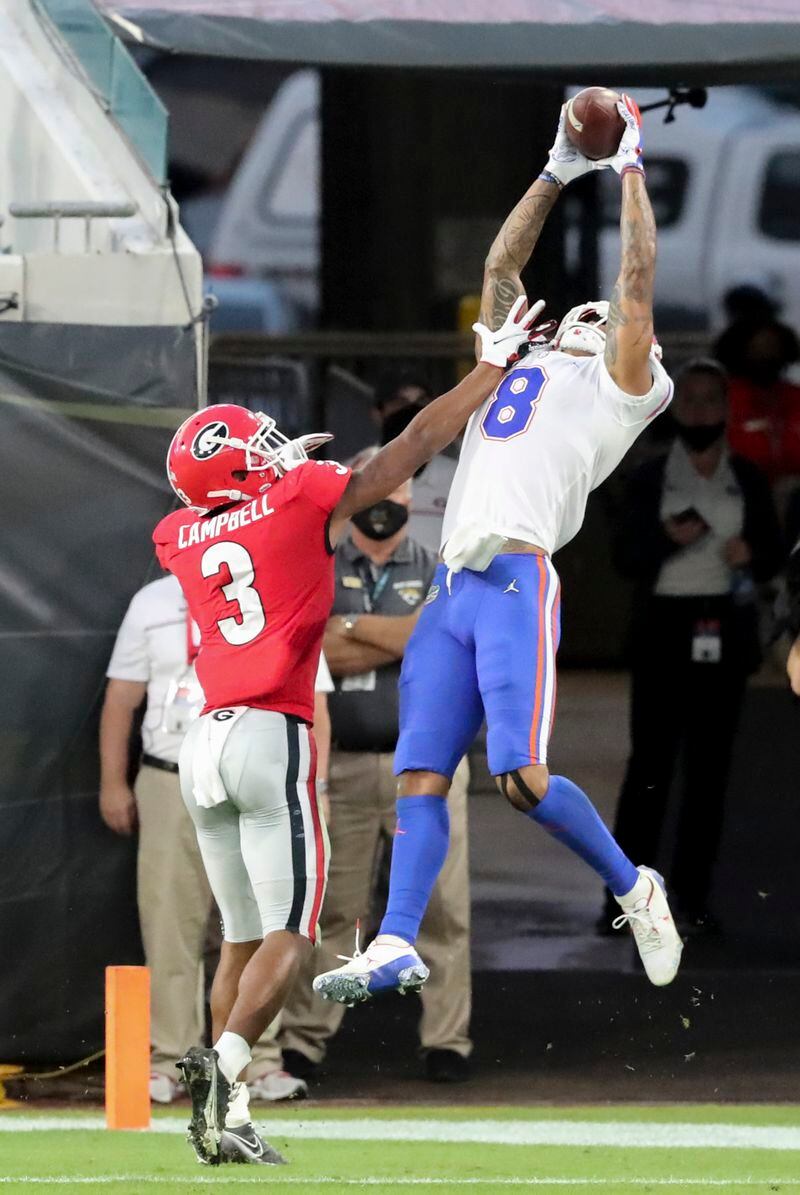 Gators wide receiver Trevon Grimes (8) makes a touchdown catch over UGA cornerback Tyson Campbell (3) at the end of the first half Saturday, Nov. 7, 2020, in Jacksonville, Fla.