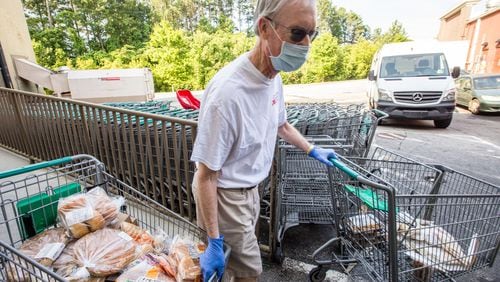 Ned Cone volunteers with Second Helping Atlanta, picking up food at Sprouts in Smyrna that is nearing its sell-by date and transporting it to the Atlanta Mission on Tuesday, June 2, 2020. (Jenni Girtman for The Atlanta Journal-Constitution)