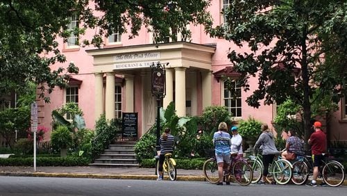 Bike-riding tourists stop at The Olde Pink House restaurant in Savannah.