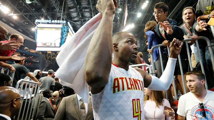 Paul Millsap celebrates a 116-98 Hawks victory over the Wizards with fans after Game 3 of a first-round NBA basketball playoff series on Saturday, April 22, 2017, in Atlanta. Curtis Compton/ccompton@ajc.com