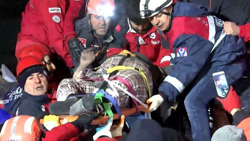 Rescue workers carry a wounded person after they rescued him from the debris of a collapsed building following a strong earthquake in Elazig in the eastern Turkey.