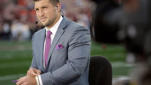 FILE - Tim Tebow speaks on ESPN before the NCAA BCS National Championship college football game between Auburn and Florida State in this Monday, Jan. 6, 2014 file photo taken in Pasadena, Calif. Many critics might have written him off and he's got a TV gig with the SEC Network, but as long as the polarizing quarterback is still available, plenty will wonder if anyone will sign him. (AP Photo/David J. Phillip, File) Urban Meyer should know there's a reason Tim Tebow is wearing a suit, not a uniform. (AP)