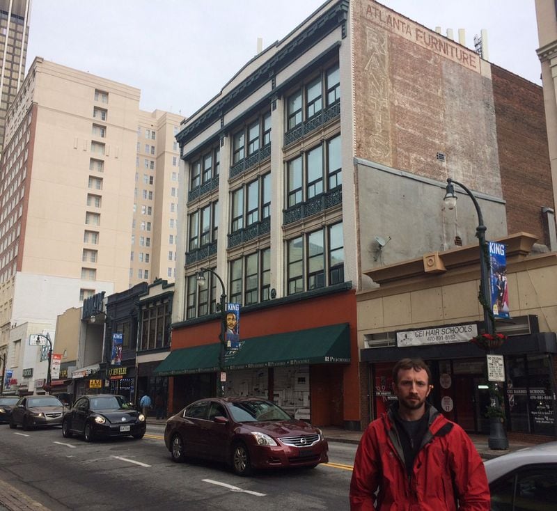 Kyle Kessler, a resident of south downtown Atlanta, stands across Peachtree Street near the original Rich’s department store (the four-story building). Photo by Bill Torpy