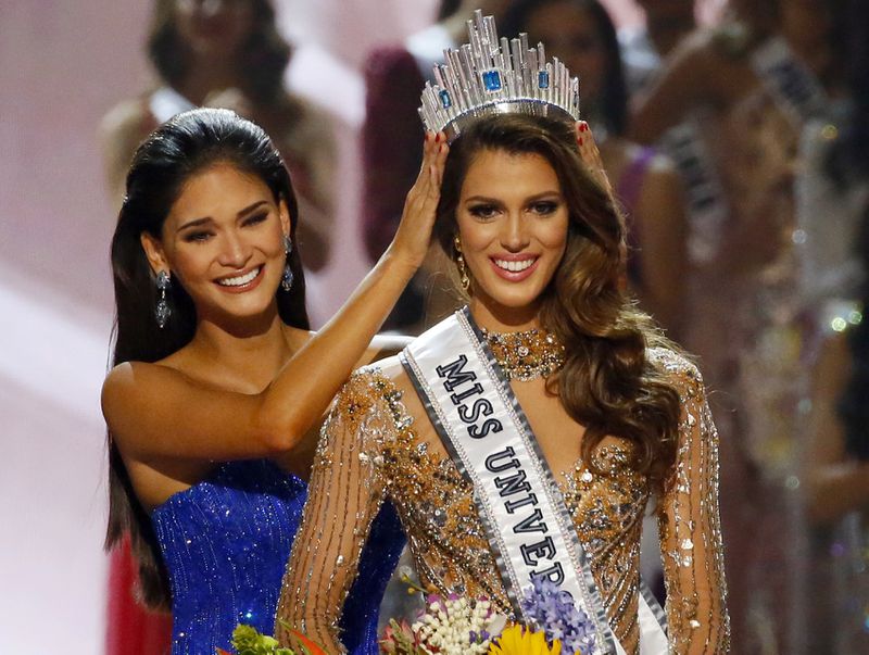 Iris Mittenaere of France is crowned the new Miss Universe 2016 by 2015 Miss Universe Pia Wurtzbach in coronation Monday, Jan. 30, 2017, at the Mall of Asia in suburban Pasay city, south of Manila, Philippines. (AP Photo/Bullit Marquez)