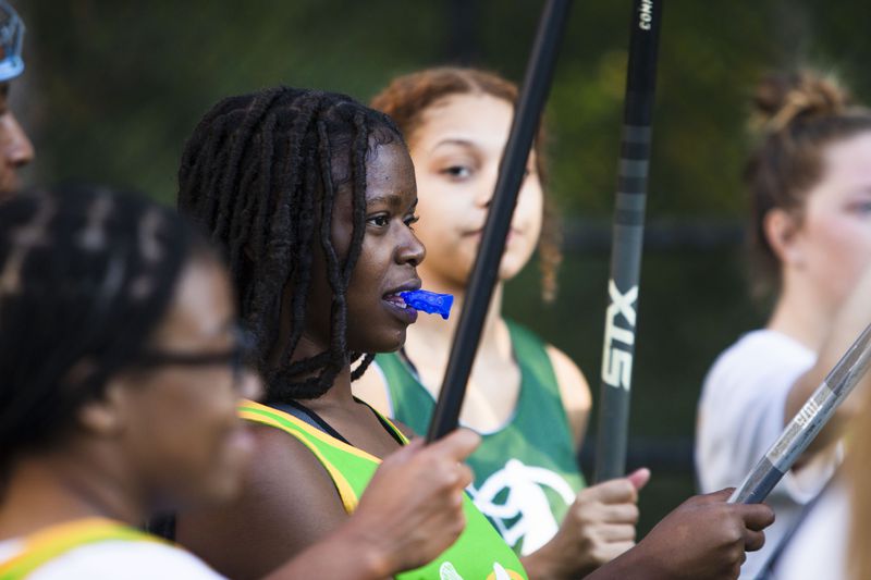 Natajha Graham listens to a teammate speak during half-time of the Spelman College lacrosse game on Sunday, October 23, 2022, at Hammond Park in Sandy Springs, Georgia. Several girls on the Spelman team said that joining the lacrosse team was the first time they felt a part of something on campus. CHRISTINA MATACOTTA FOR THE ATLANTA JOURNAL-CONSTITUTION.