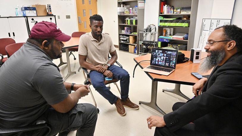 Kinnis Gosha (left), the Hortinius I. Chenault Endowed Division Chair for Experiential Learning and Interdisciplinary Studies, speaks to students as Rodney Sampson (right), chairman & CEO of OHUB, and Corey Shaw, Morehouse student, look during an online coding bootcamp created by Morehouse College at Morehouse College on Tuesday, June 9, 2020.