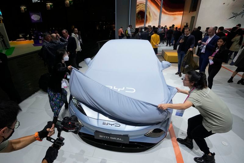 FILE - Chinese EV manufacturer BYD unveils its electric car Seal at the Paris Car Show on Oct. 17, 2022, in Paris. Europe wants two things from China: First, a shift in its relatively pro-Russia position on the war in Ukraine. Second, a reduction in the trade imbalance. It’s not clear if it will get very far on either front. (AP Photo/Michel Euler, File)
