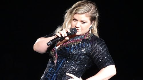 Kelly Clarkson does a mock pose for a fan right before she finishes her signature encore song "Since U Been Gone."