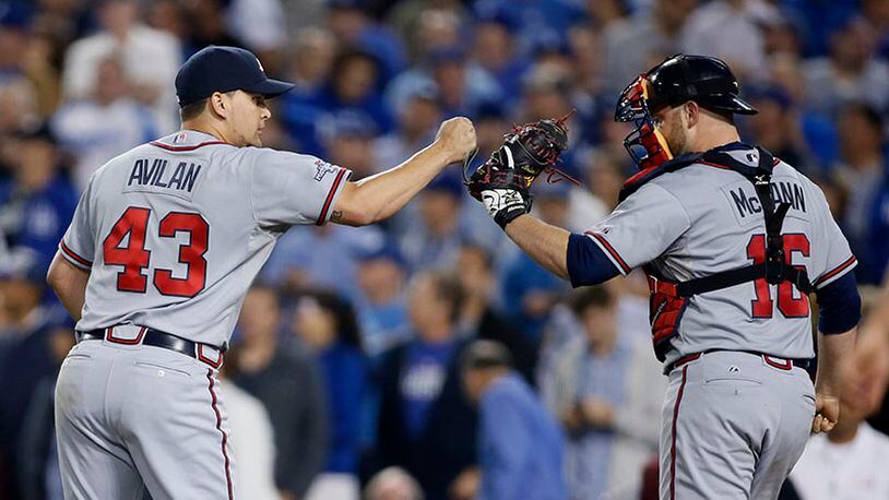 Braves catcher Brian McCann and reliever Luis Avilan (left) fist-bump after getting out of a jam in the seventh inning of Game 4 of the NLDS in Los Angeles.