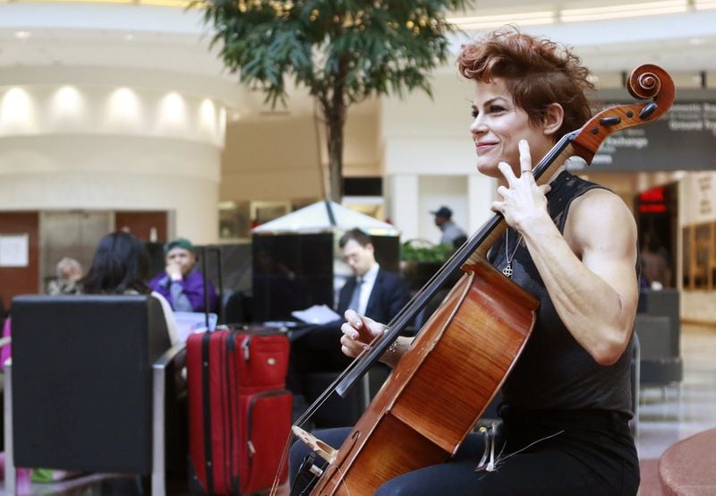 Jenn Cornell plays cello in the domestic terminal atrium. Hartsfield-Jackson hires live musicians to calm and entertain travelers in the terminal and on the concourses. BOB ANDRES /BANDRES@AJC.COM
