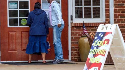 People walk into the Johns Creek early voting polling location on March 14, 2020. STEVE SCHAEFER / SPECIAL TO THE AJC