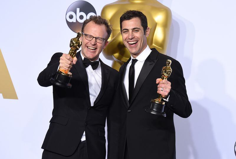 ** EMBARGOED AT THE REQUEST OF THE ACADEMY OF MOTION PICTURE ARTS &amp; SCIENCES FOR USE UPON CONCLUSION OF THE ACADEMY AWARDS TELECAST ** Tom McCarthy, left, and Josh Singer pose with the award for best original screenplay for Spotlight in the press room at the Oscars on Sunday, Feb. 28, 2016, at the Dolby Theatre in Los Angeles. (Photo by Jordan Strauss/Invision/AP)