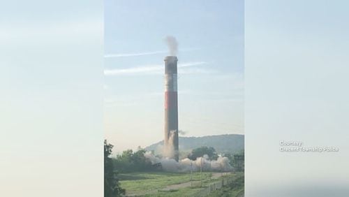 A smokestack was supposed to come down in a controlled implosion, but something went wrong and it is still standing.