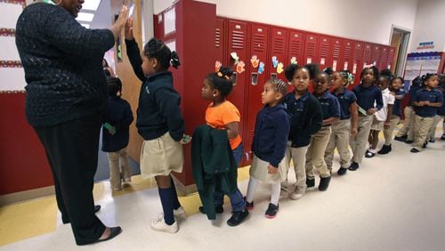 Kindergarteners enter a classroom at Ivy Prep, a state-commissioned charter school in the Kirkwood neighborhood of Atlanta. AJC/ JASON GETZ