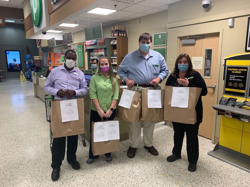 Employees of the Publix at Johnson Ferry and Ashford-Dunwoody roads in Brookhaven accept 90 rice bowls from Verde Taqueria. The meals were donated to support essential workers during the pandemic. Courtesy of Matt Gunter