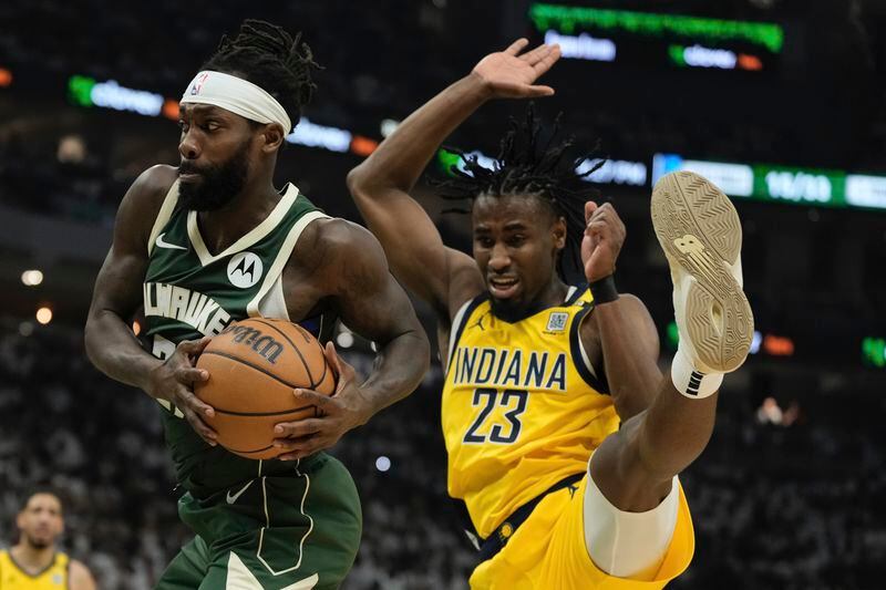 Milwaukee Bucks' Patrick Beverley rebounds in front of Indiana Pacers' Aaron Nesmith during the first half of Game 2 of the NBA playoff basketball game Tuesday, April 23, 2024, in Milwaukee. (AP Photo/Morry Gash)