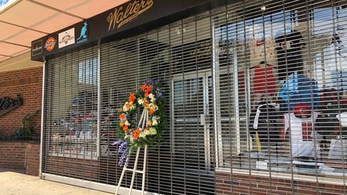 Walter Strauss, founder of Walter’s Clothing, a downtown institution, died at 94. A wreath is placed outside the store.