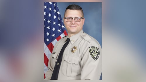 Coweta County sheriff's Deputy Eric Minix was killed late Wednesday night after a pursuit that ended in Alabama.