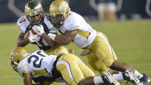September 3, 2015 Atlanta - Alcorn State Braves wide receiver Marquis Warford (10) gets tackled by Georgia Tech Yellow Jackets defensive back Lawrence Austin (20) and Georgia Tech Yellow Jackets linebacker Victor Alexander (9) in the first half of the Georgia Tech season opener in Bobby Dodd Stadium on Thursday, September 3, 2015. HYOSUB SHIN / HSHIN@AJC.COM