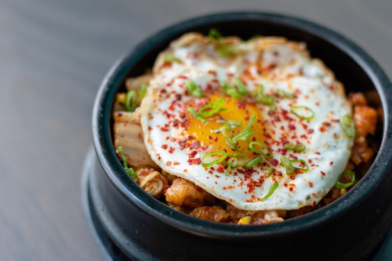 Duluth’s Noona Steakhouse & Oyster Bar serves its kimchi fried rice with a fried egg on top. CONTRIBUTED BY HENRI HOLLIS