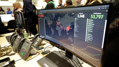 A monitor displays world-wide statistics relating to the spread of the COVID-19 coronavirus during a visit of Vice President Mike Pence to the Washington State Emergency Operations Center Thursday at Camp Murray in Washington state.