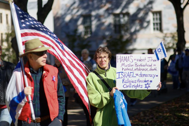 Judy Bloom (center) carries a sign as she marches into the Emory campus during a peaceful rally to show solidarity of students’ safety and the increased antisemitism and Islamophobia on college campuses in Georgia on Wednesday, November 1, 2023, in Atlanta



Miguel Martinez /miguel.martinezjimenez@ajc.com