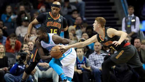 Michael Kidd-Gilchrist of the Charlotte Hornets drives to the basket against teammates Kevin Huerter  and Vince Carter of the Atlanta Hawks during their game at Spectrum Center on December 08, 2019 in Charlotte, North Carolina. NOTE TO USER: User expressly acknowledges and agrees that, by downloading and or using this photograph, User is consenting to the terms and conditions of the Getty Images License Agreement. (Photo by Streeter Lecka/Getty Images)