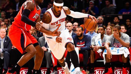 The Knicks’ Carmelo Anthony (7) attempts to drive past the Hawks’ Paul Millsap (4) in a game last week. (Photo by Alex Goodlett/Getty Images)