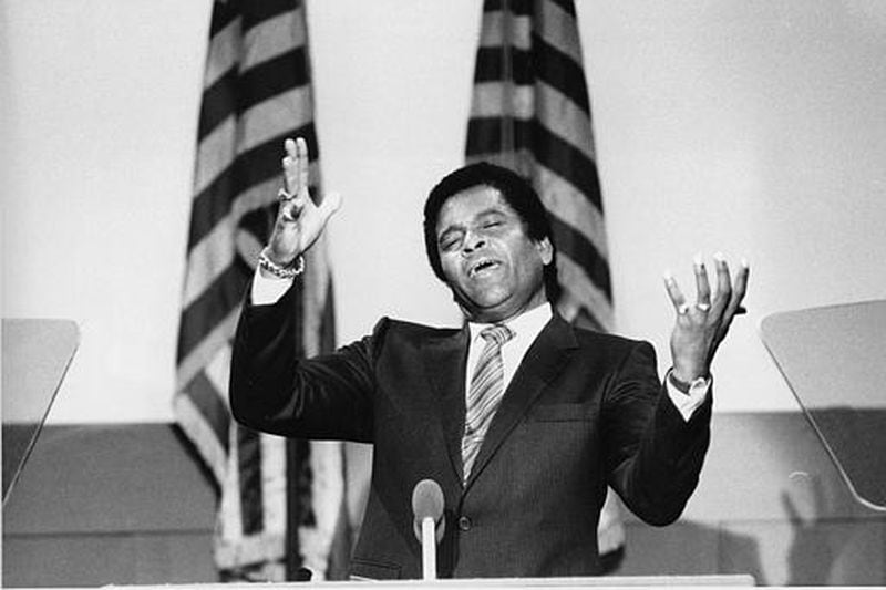Country singer Charley Pride sings the national anthem during the third session of the Democratic National Convention at the podium of Moscone Center in San Francisco, on July 18, 1984. (AP Photo/Ira Schwarz)