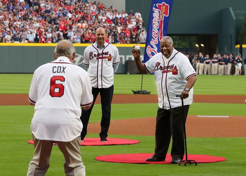Hank Aaron throws out the first pitch to Bobby Cox with John Smoltz looking on at the Braves home opener against the Padres at SunTrust Park on Friday, April 14, 2017.