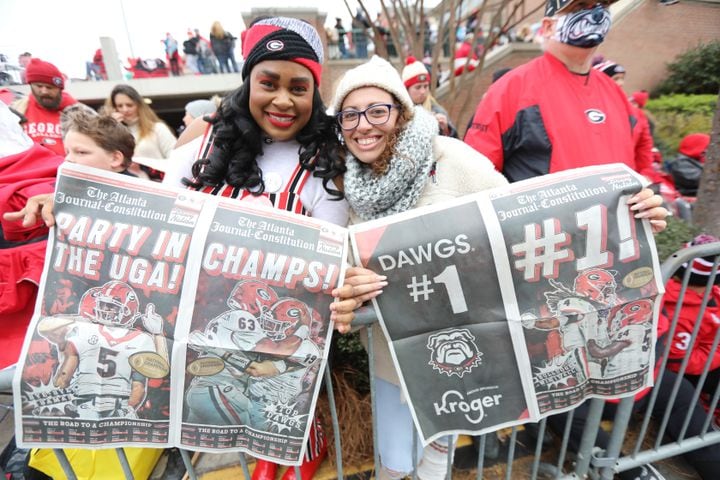 Amber Smith (left) and Nataly Gonzalez cheer for the Georgia Bulldogs as they way for them to do the dog walk during the victory parade in downtown Athens onSaturday, January 15, 2022 Miguel Martinez for The Atlanta Journal-Constitution