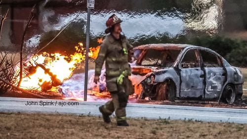 Leaking gas fed a fire on Grayson Highway after a car crashed into a power pole and ruptured a gas line.