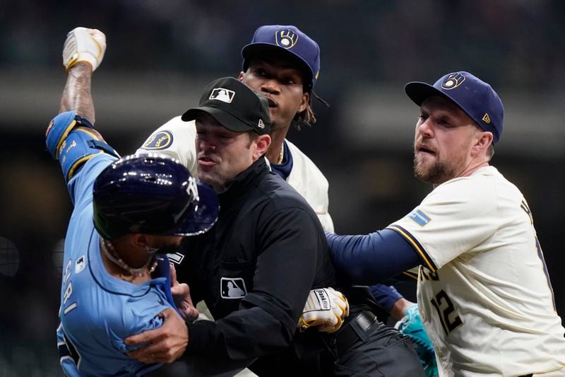 Tampa Bay Rays' Jose Siri, left, fights with Milwaukee Brewers' Abner Uribe, middle, during the eighth inning of a baseball game Tuesday, April 30, 2024, in Milwaukee. (AP Photo/Aaron Gash)