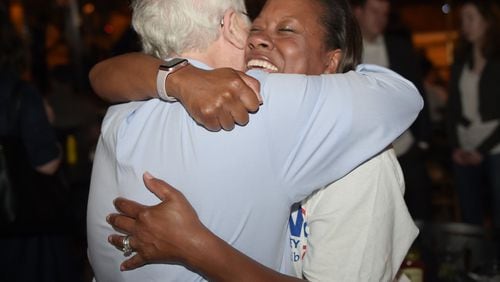 DeKalb DA candidate Sherry Boston celebrates with former prosecutor Bob Wilson at a watch party where she celebrated her win over incumbent Robert James during Tuesday’s primary. KENT D. JOHNSON/kdjohnson@ajc.com