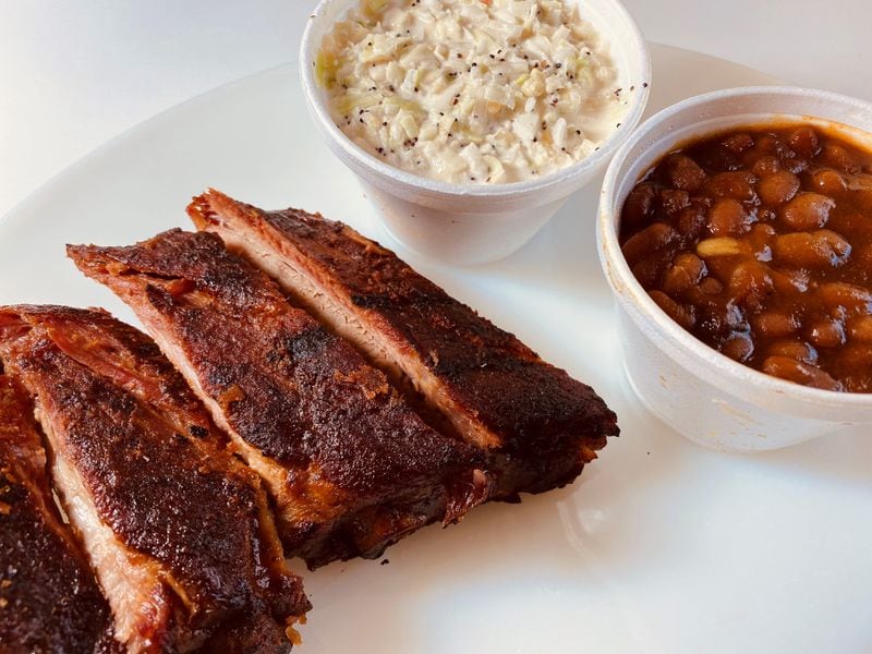 This order of St. Louis-cut spareribs from Dave Poe's BBQ is served with coleslaw and baked beans. Bob Townsend for The Atlanta Journal-Constitution 
