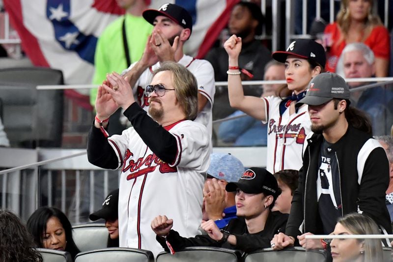 Travis Tritt cheers with fans during the sixth inning of the game between the Atlanta Braves and the Los Angeles Dodgers in game 6 at the National League Championship Series at Truist Park, Saturday October 23, 2021, in Atlanta. Tritt sang the national anthem. Hyosub Shin / Hyosub.Shin@ajc.com
