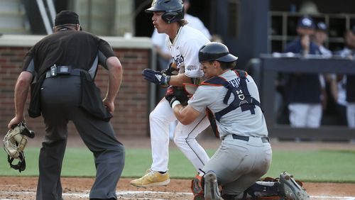 Auburn catcher Carter Wright tags out Georgia Tech's Drew Burress at home during the third inning at Russ Chandler Stadium, Tuesday, May 7, 2024, in Atlanta. The Jackets lost 7-2. (Jason Getz / AJC)
