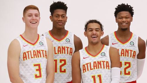 Hawks players Kevin Huerter (from left), De'Andre Hunter, Trae Young, and Cam Reddish share a laugh during team photos on media day on Monday, Sept. 30, 2019, in Atlanta.