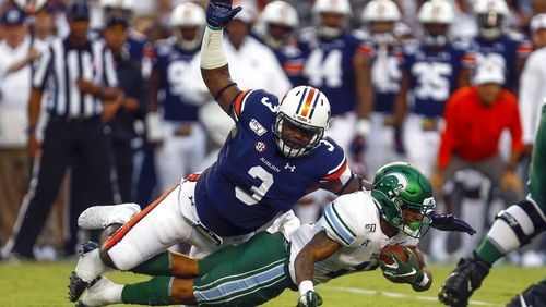 Tulane running back Amare Jones is tackled for a loss by Auburn defensive end Marlon Davidson (3). (AP Photo/Butch Dill, File)