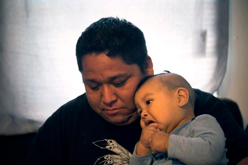 On March 26, 2017, Armando Hernandez played with his nine-month-old son, Liam Hernandez in their trailer home on the Kickapoo reservation outside of Eagle Pass, Texas. Originally from the Great Lakes region, the Kickapoo Traditional Tribe of Texas also has reservations in northern Mexico, which they visit frequently. Hernandez and his wife, Kelly Hernandez, worry that President Donald Trump's impending wall will limit their family's ability to go to Mexico.  "Our elders tell stories about not being able to leave, about being caged in," said Armando Hernandez. 