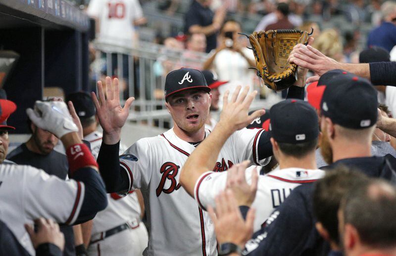 October 7, 2018 - Atlanta: Atlanta Braves starting pitcher Sean Newcomb gets high fives from teammates in the dugout in the third inning against the Los Angeles Dodgers during Game 3 of a National League Division Series baseball game Sunday, October 7, 2018, in Atlanta. Curtis Compton/ccompton@ajc.com