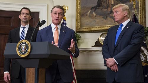 U.S. Sen. David Perdue, R-Ga., makes an announcement Wednesday on the introduction of the Reforming American Immigration for a Strong Economy (RAISE) Act at the White House. The act aims to overhaul U.S. immigration by moving toward a “merit-based” system. Also pictured are U.S. Sen. Tom Cotton, R-Ark., left, and President Donald Trump. (Photo by Zach Gibson - Pool/Getty Images)