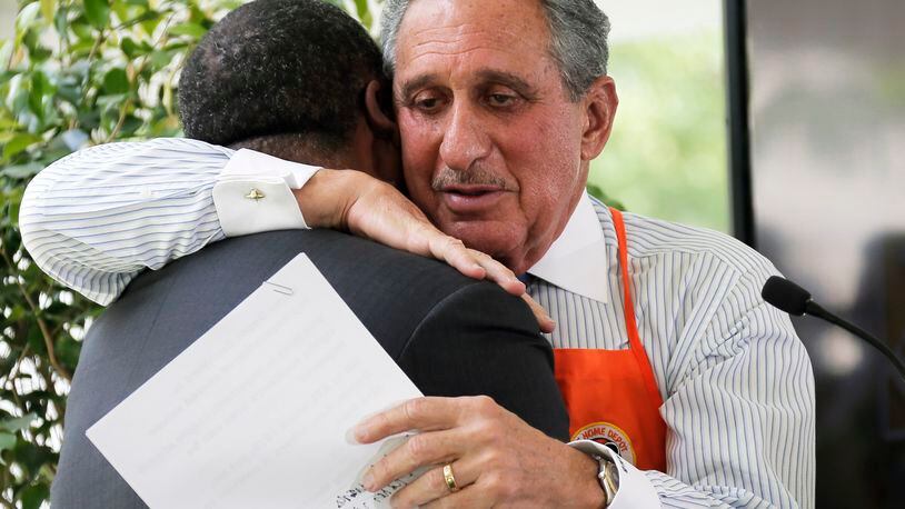 April 21,  2017 - Atlanta - Arthur Blank hugs Mayor Kasim Reed after Reed gave a warm introduction when the team unveiled plans for the "Home Depot Backyard."