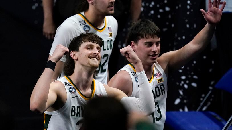 Baylor guard Matthew Mayer, left, celebrates as he walks off the court at the end of a men's Final Four NCAA college basketball tournament semifinal game against Houston, Saturday, April 3, 2021, at Lucas Oil Stadium in Indianapolis. Baylor won 78-59. (AP Photo/Darron Cummings)