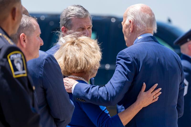 President Joe Biden, right, speaks with Charlotte, N.C., Mayor Vi Lyles, bottom center, and North Carolina Gov. Roy Cooper, top center, as he arrives on Air Force One at Charlotte Douglas International Airport, Thursday, May 2, 2024, in Charlotte, N.C. Biden is meeting with the families of law enforcement officers shot to death on the job. (AP Photo/Alex Brandon)