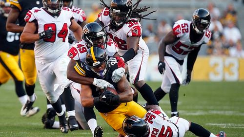 PITTSBURGH, PA - AUGUST 20:  James Conner #30 of the Pittsburgh Steelers rushes against Kemal Ishmael #36, Deron Washington #49 and Marcelis Branch #35 of the Atlanta Falcons during a preseason game at Heinz Field on August 20, 2017 in Pittsburgh, Pennsylvania.  (Photo by Justin K. Aller/Getty Images)