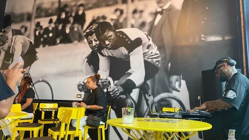 A mural of cyclist Major Taylor covers a wall inside the Handlebar. / Courtesy of the Handlebar