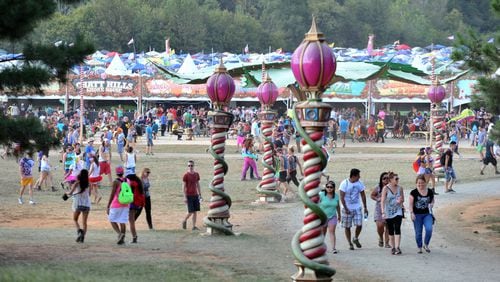 September 27, 2014 Chattahoochee Hills - Event-goers walk their way during the TomorrowWorld electronic music festival in Chattahoochee Hills, South of Atlanta, on Saturday, September 27, 2014. It took about three weeks to transform the 350-acres of farm land at Bouckaert Farm in Chattahoochee Hills into the self-contained EDM haven known as TomorrowWorld.The three-day fest officially kicked off at noon Friday and the pulsing bass won't cease until the early hours of Monday morning. HYOSUB SHIN / HSHIN@AJC.COM The European vibe of TomorrowWorld is seen in the concession areas. HYOSUB SHIN / HSHIN@AJC.COM