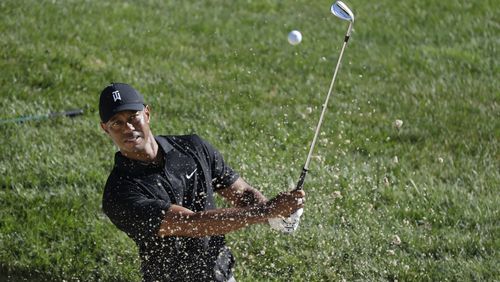 Tiger Woods gets in a little work from out of the bunker during a Tuesday morning practice round for the upcoming Memorial Tournament. (AP Photo/Darron Cummings)